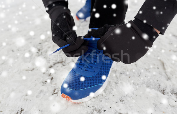 close up of man tying shoe lace in winter outdoors Stock photo © dolgachov