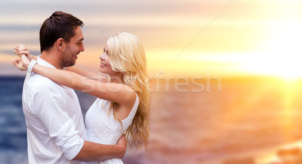 happy couple hugging over sea background Stock photo © dolgachov