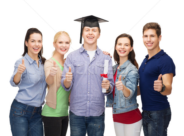 group of students with diploma showing thumbs up Stock photo © dolgachov