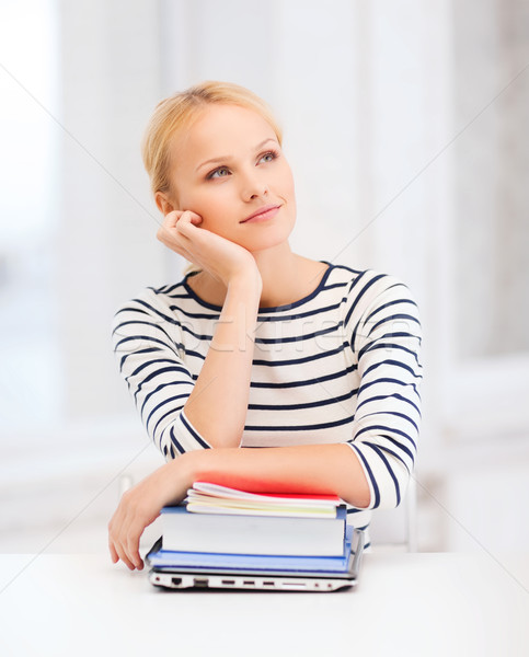 dreaming student with laptop, books and notebooks Stock photo © dolgachov