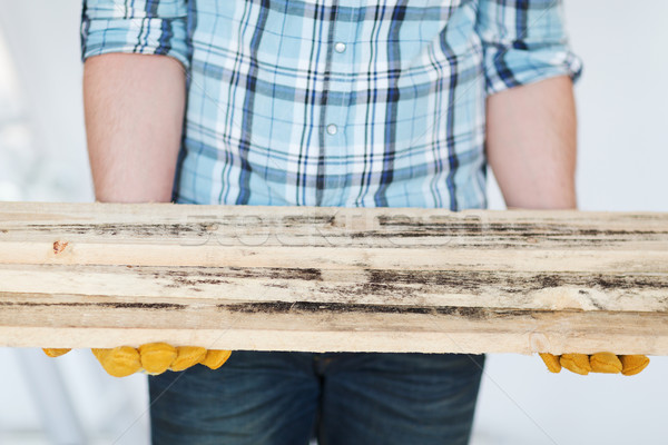 close up of male in gloves carrying wooden boards Stock photo © dolgachov