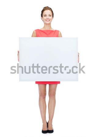 smiling woman in sweater with blank white board Stock photo © dolgachov