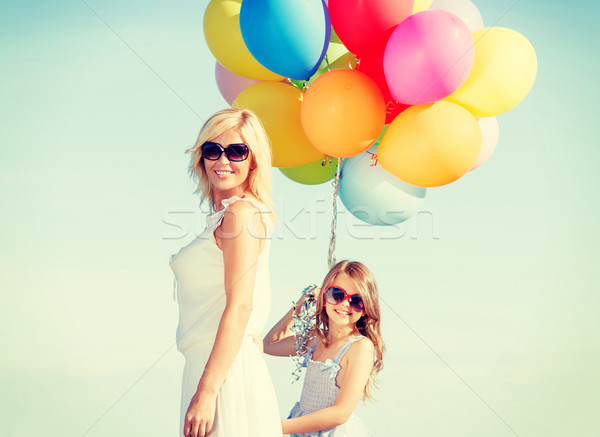 mother and child with colorful balloons Stock photo © dolgachov