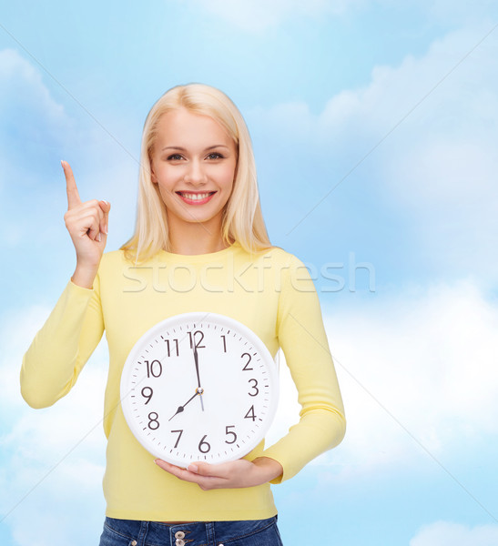 student with wall clock and finger up Stock photo © dolgachov