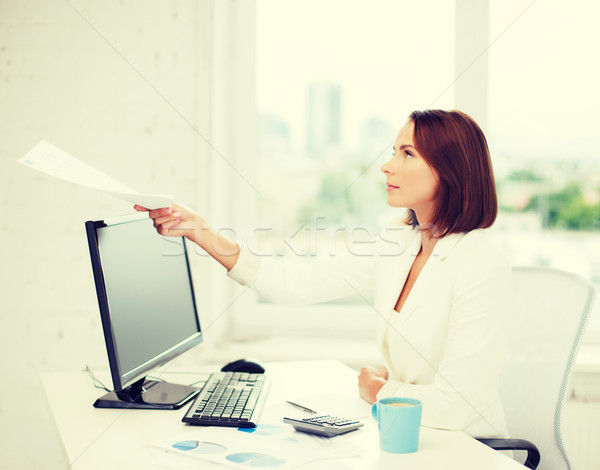 businesswoman giving papers in office Stock photo © dolgachov