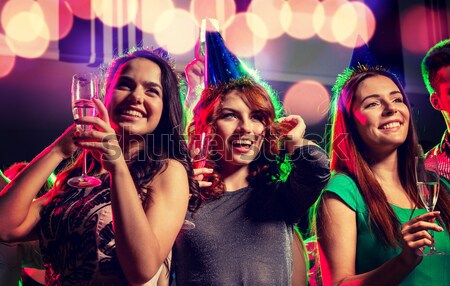Três sorridente mulheres dança cantando karaoke Foto stock © dolgachov