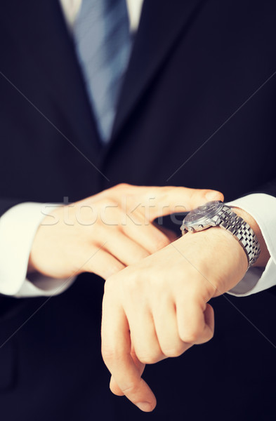 man looking at wristwatch Stock photo © dolgachov