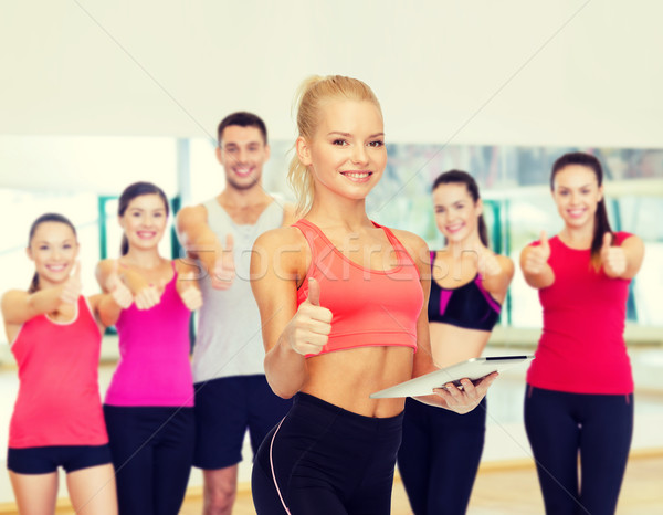 smiling sporty woman with tablet pc computer Stock photo © dolgachov