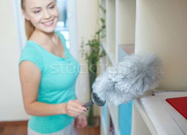 happy woman with duster cleaning at home Stock photo © dolgachov