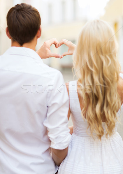 romantic couple in the city making heart shape Stock photo © dolgachov