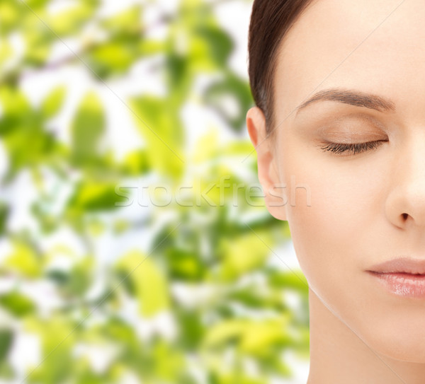 young woman face over green leaves background Stock photo © dolgachov