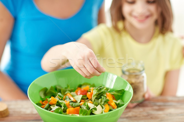 close up of happy family cooking salad in kitchen Stock photo © dolgachov