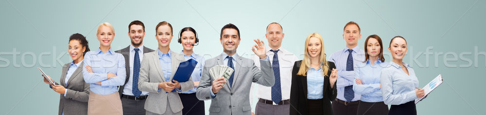 group of happy businesspeople with dollar money Stock photo © dolgachov