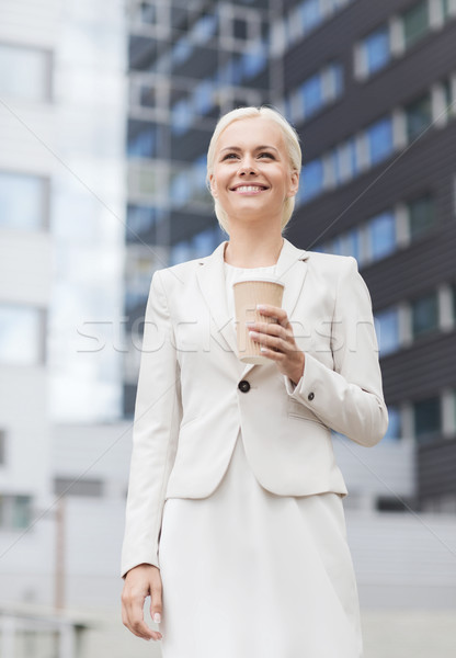 smiling businesswoman with paper cup outdoors Stock photo © dolgachov