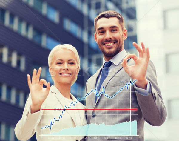 Stock photo: smiling businessmen standing over office building