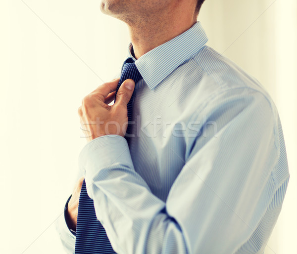 close up of man in shirt adjusting tie on neck Stock photo © dolgachov