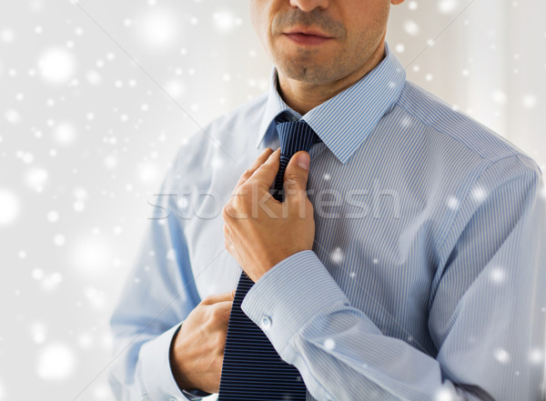 close up of man in shirt adjusting tie on neck Stock photo © dolgachov