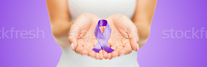 close up of hands holding purple awareness ribbon Stock photo © dolgachov
