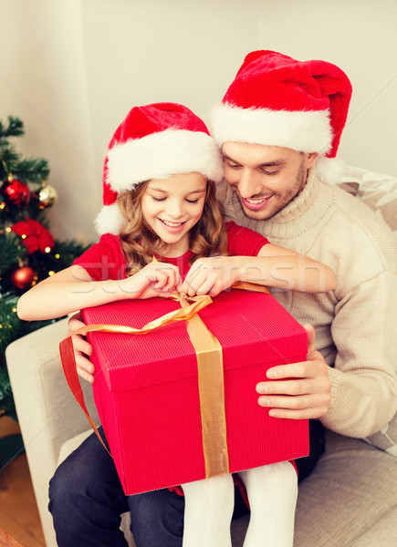Stock photo: smiling father and daughter opening gift box