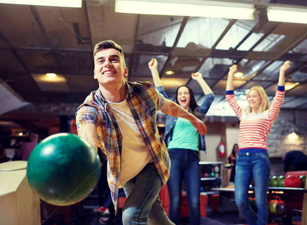 happy young man throwing ball in bowling club Stock photo © dolgachov