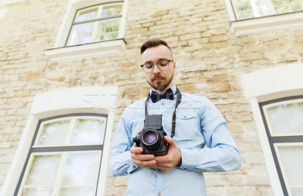 happy young hipster man with film camera in city Stock photo © dolgachov