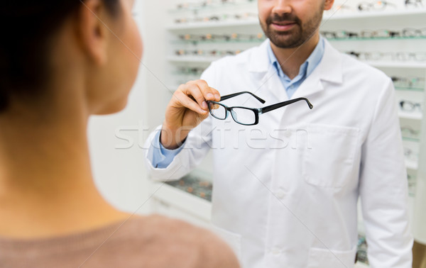 close up of optician with glasses at optics store Stock photo © dolgachov