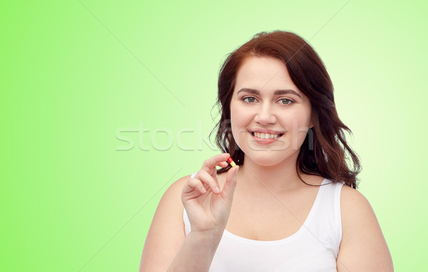 happy plus size woman in underwear with pill Stock photo © dolgachov