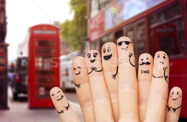 close up of hands and fingers with smiley faces Stock photo © dolgachov