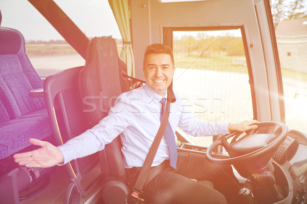 happy driver inviting on board of intercity bus Stock photo © dolgachov