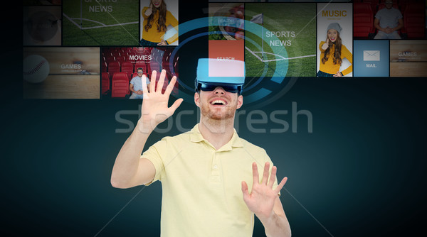 happy man in virtual reality headset or 3d glasses Stock photo © dolgachov