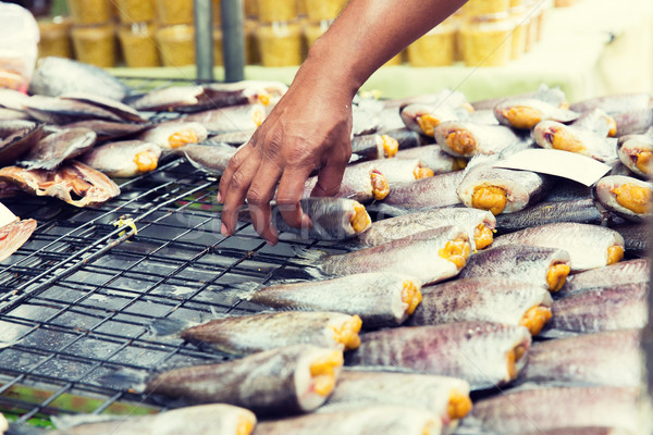 close up of hand taking fish at street market Stock photo © dolgachov