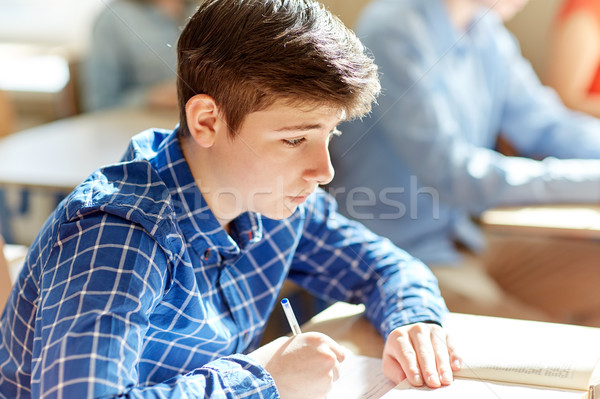 group of students with books writing school test Stock photo © dolgachov