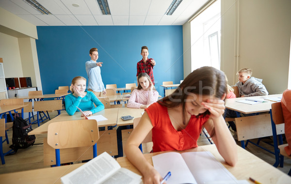 students gossiping behind classmate back at school Stock photo © dolgachov