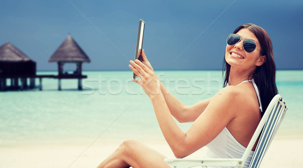 Сток-фото: улыбающаяся · женщина · солнечные · ванны · пляж · Летние · каникулы · туризма