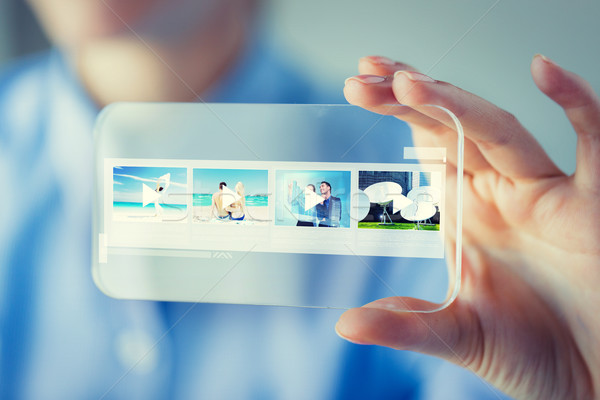 close up of woman with transparent smartphone Stock photo © dolgachov