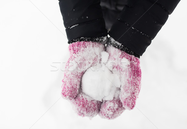 Stock photo: close up of woman holding snowball outdoors