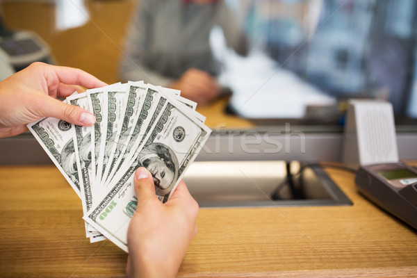 hands with money at bank office or exchanger Stock photo © dolgachov