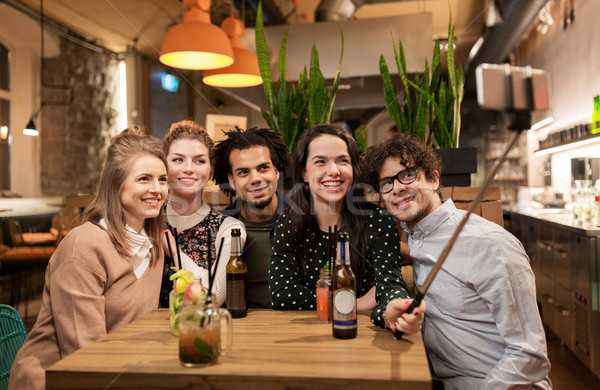 Stock photo: friends taking selfie by smartphone at bar or cafe