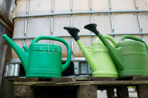 watering cans at farm water tank Stock photo © dolgachov