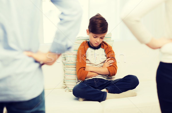 upset or feeling guilty boy and parents at home Stock photo © dolgachov