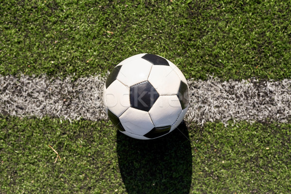 soccer ball on football field marking line Stock photo © dolgachov