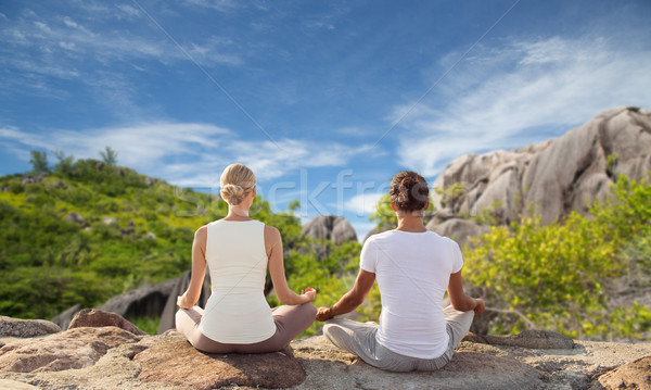 couple meditating in yoga lotus pose outdoors Stock photo © dolgachov