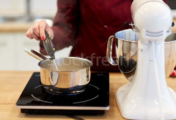 chef measuring temperature in pot at kitchen Stock photo © dolgachov