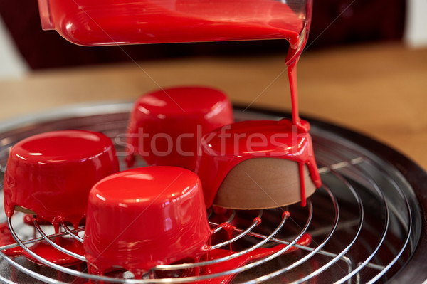jug pouring glaze to cakes at pastry shop Stock photo © dolgachov