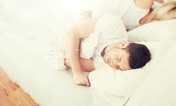 couple sleeping in bed at home Stock photo © dolgachov