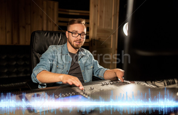 sound engineer at recording studio mixing console Stock photo © dolgachov