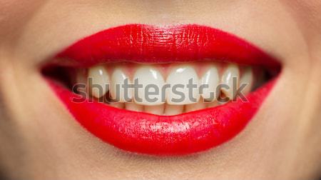 close up of woman with red lipstick licking lips Stock photo © dolgachov