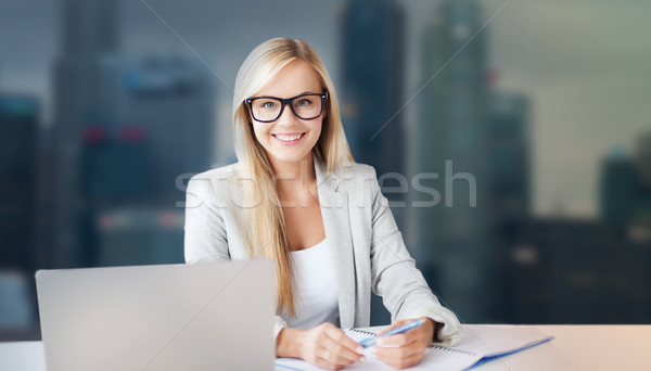 businesswoman with notepad and laptop at office Stock photo © dolgachov