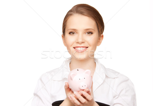 Stock photo: lovely woman with piggy bank