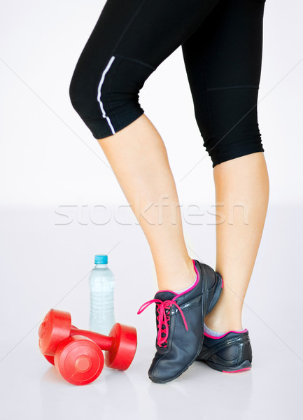 sporty woman legs with light red dumbbells Stock photo © dolgachov